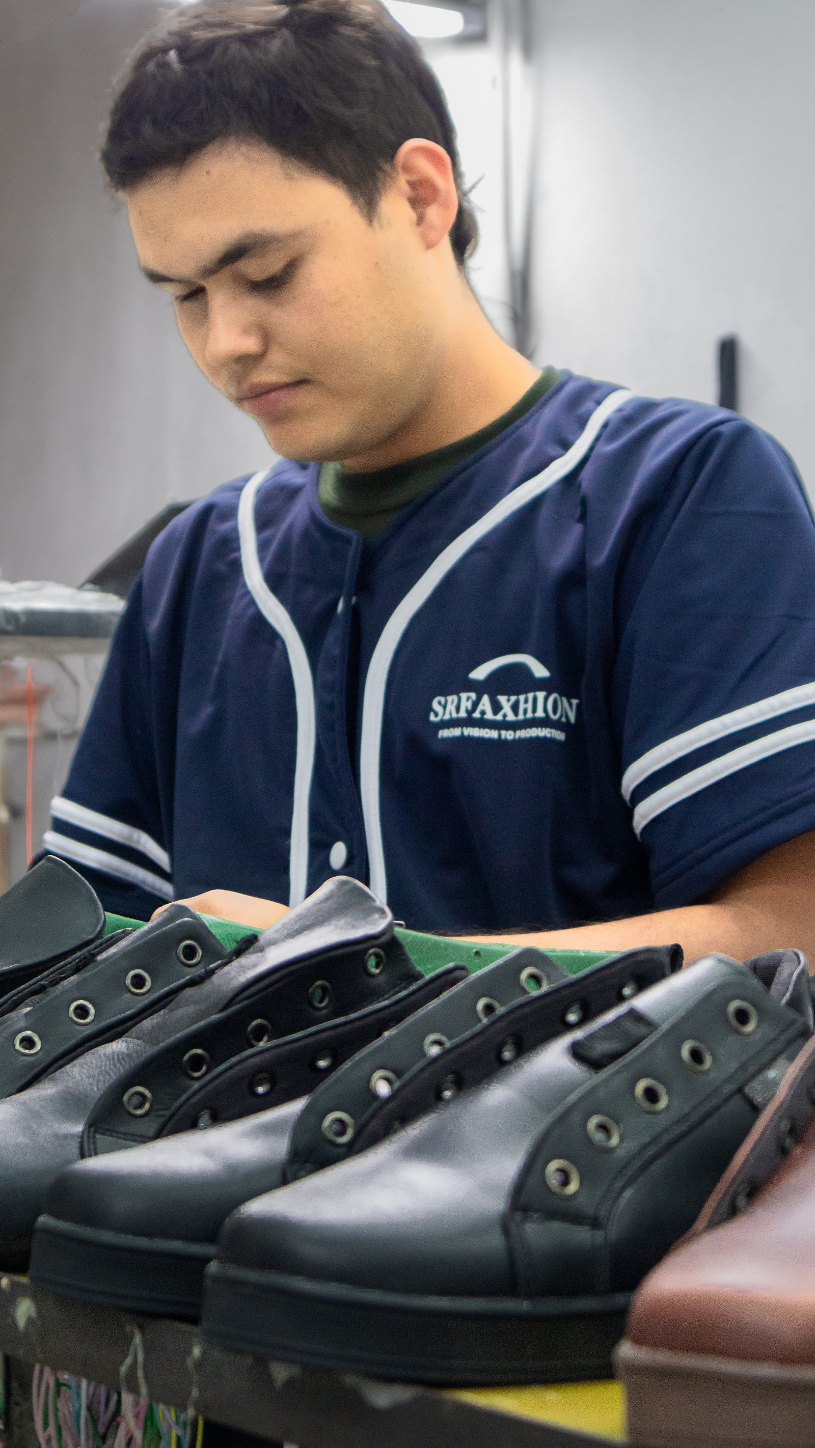 SR Faxhion worker inspecting footwear during quality control